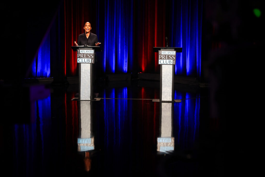Bottoms Stands Before Empty Podium as Jackson Campaigns with Kemp Instead of Debating