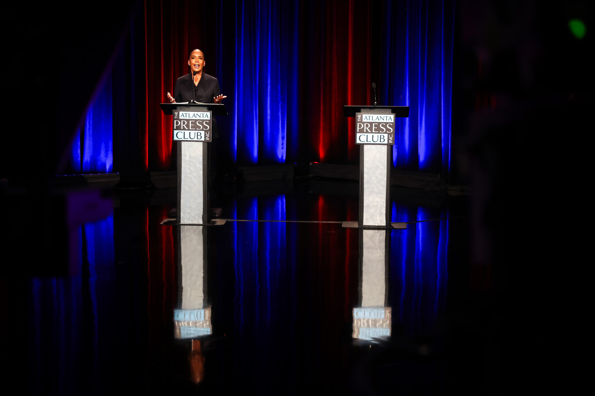 Bottoms Stands Before Empty Podium as Jackson Campaigns with Kemp Instead of Debating